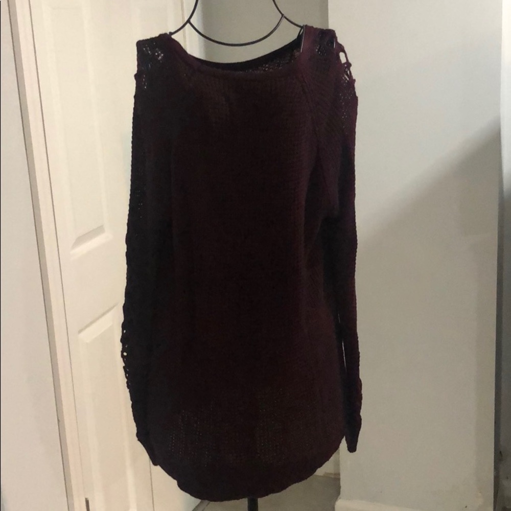 Maroon sweater with detail on sleeve